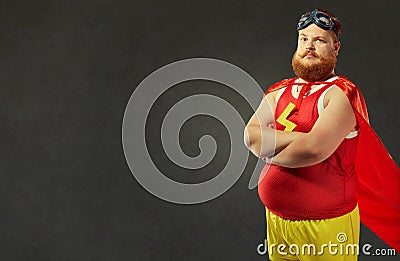 Fat funny man in a superhero costume. Stock Photo