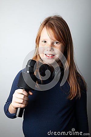 Fat girl singing song into microphone. Young star, looking for talents Stock Photo