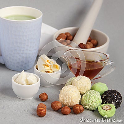 Fat keto peanut butter, cheesecake, matcha balls and keto matcha coconut bulletproof tea in blue cup. keto protein balls and Stock Photo
