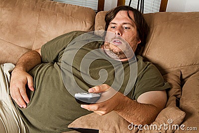 Fat lazy guy on the couch Stock Photo