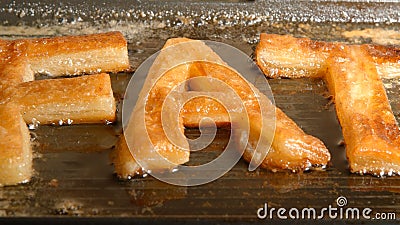 FAT letters fry in oil in a pan close up - front view Stock Photo