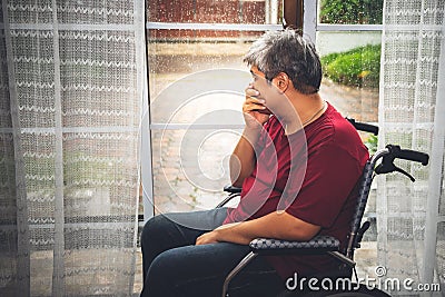 fat man is upset and stressed, He was a patient sitting in a wheelchair Stock Photo
