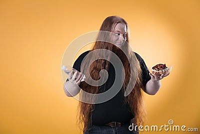 A fat red-haired man holds water and a cake. Stock Photo