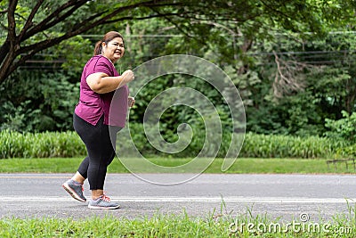Fat woman asian running at the park, Stock Photo