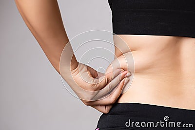 Fat woman hand holding excessive belly fat. Healthcare and woman diet lifestyle concept to reduce belly and shape up healthy Stock Photo