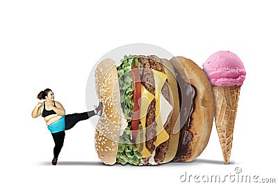 Fat woman kicks burger and ice cream Stock Photo