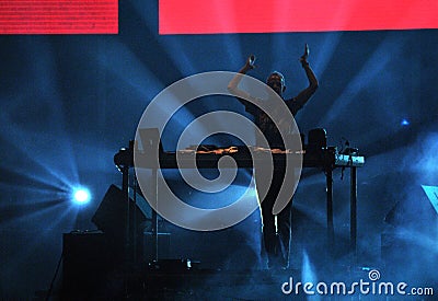 Fatboy Slim mixing live in the front of a crowd of people Editorial Stock Photo
