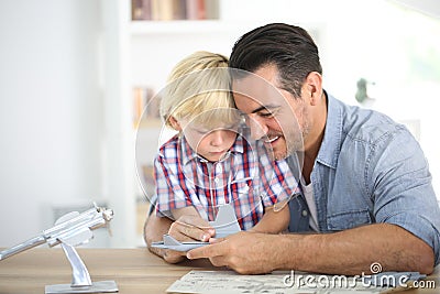 Father assembling toy with his son Stock Photo