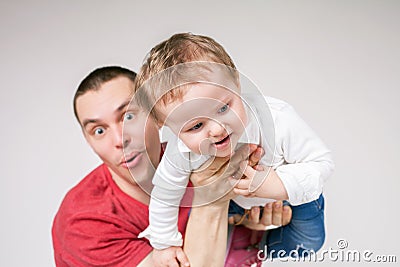 Father with baby, flying above head Stock Photo