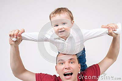 Father with baby, flying above head Stock Photo