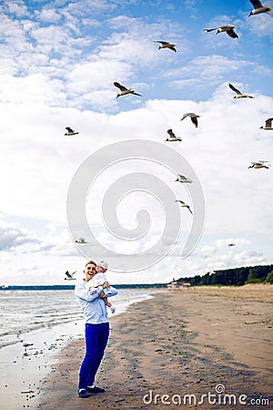 Father in the blue dress nautical throws his little daughter Stock Photo