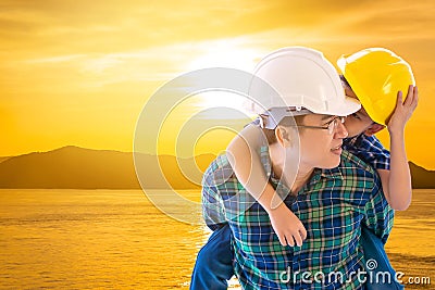 Father builder carrying his son in golden sky cloud island sea and family boding future concept Stock Photo