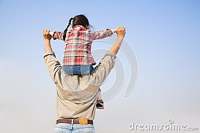 Father carrying his daughter on shoulders Stock Photo