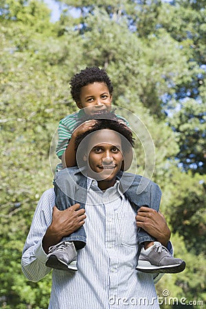 Father carrying son. Stock Photo