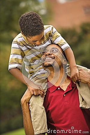 Father carrying son Stock Photo