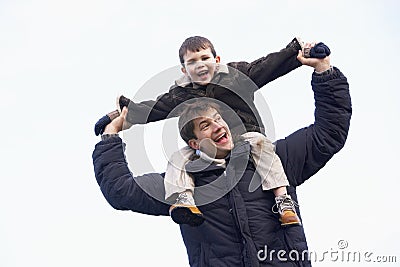 Father Carrying Son On His Shoulders Stock Photo