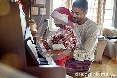 Father with child girl on Christmas play music on piano Stock Photo