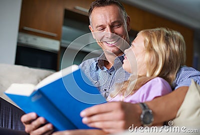 Father, child and reading a book for learning at home, story and fantasy fiction for education. Daddy, daughter and Stock Photo