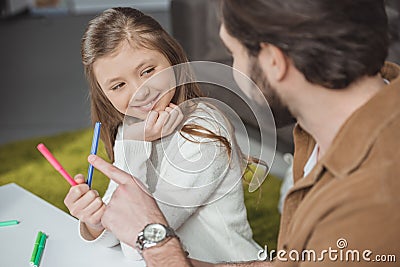 father choosing colored felt-tip pen Stock Photo