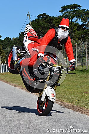 Father Christmas doing front wheel wheelie Editorial Stock Photo