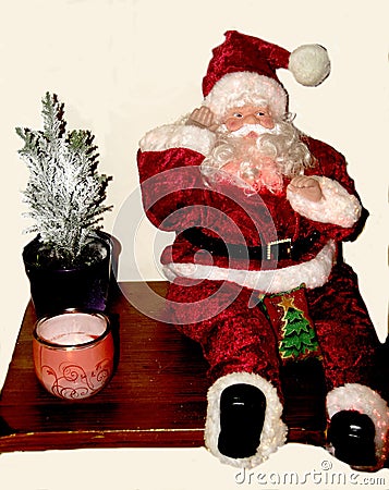 Father Christmas with last present to deliver on a white background. Stock Photo