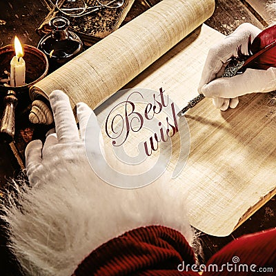 Father Christmas writing a Best Wishes greeting Stock Photo