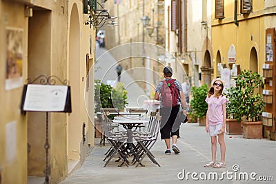 Father and daughter exploring in Montalcino town, located on top of a hill top and surrounded by vineyards, known worldwide for Stock Photo