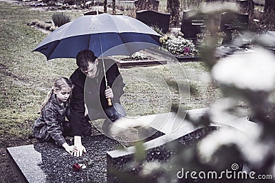 Father and daughter at grave Stock Photo