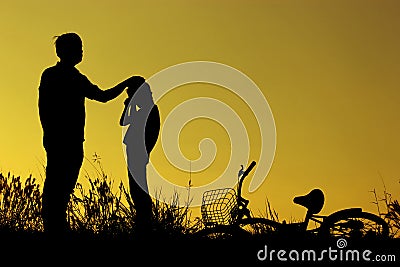 Father and daughter having fun riding bike at sunset, active family sport, active kids sport, Asian kid,Silhouette a kid at the su Stock Photo