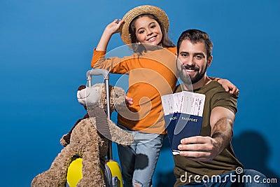 father and daughter with passports and tickets going on vacation Stock Photo