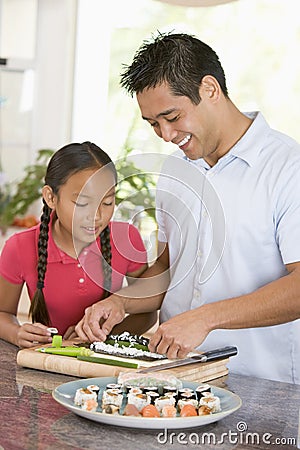 Father And Daughter Preparing Sushi Together Stock Photo