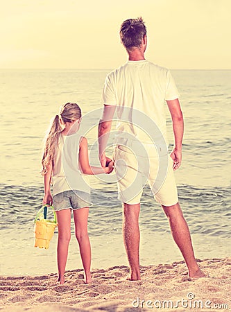 Father with daughter standing back Stock Photo