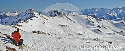 Father and daughter taking a rest sitting in front of fascinating snowy Pyrenees mountain panorama Editorial Stock Photo
