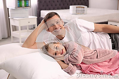Father and daughter testing mattress Stock Photo