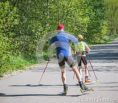 Father and daughter training on the roller skaters Editorial Stock Photo