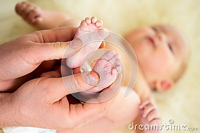 Father doctor massaging baby foot Stock Photo