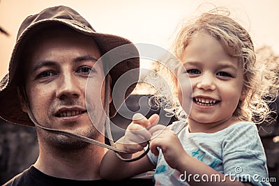 Father embracing beautiful smiling kid daughter portrait vintage style sunlight concept happy parenting lifestyle Stock Photo