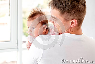 Father embracing infant Stock Photo