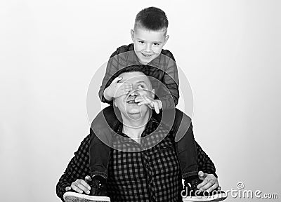 Father example of noble human. Best friends forever. Father little son red shirts family look outfit. Dad piggybacking Stock Photo