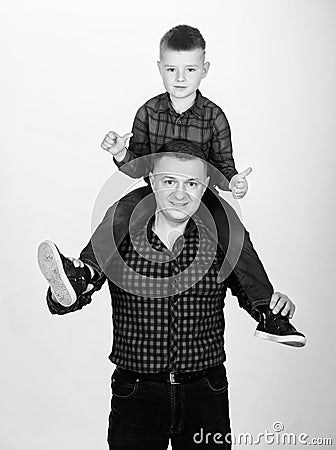 Father example of noble human. Father little son red shirts family look outfit. Best friends forever. Dad piggybacking Stock Photo