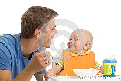 Father feeding baby son Stock Photo