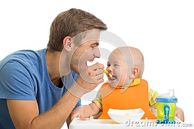 Father feeding baby son Stock Photo