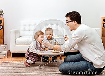 Father feeding kids Stock Photo