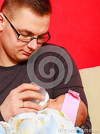 Father feeding newborn baby girl with milk bottle Stock Photo