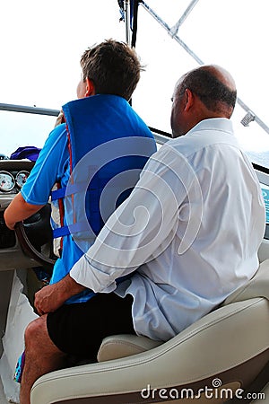 A father gives his son lessons in boating Editorial Stock Photo