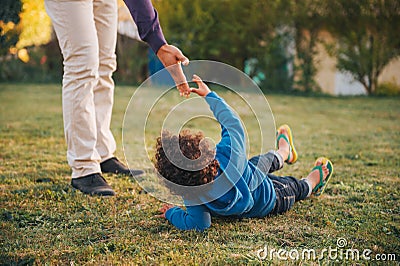 Father giving a helping hand to his son Stock Photo