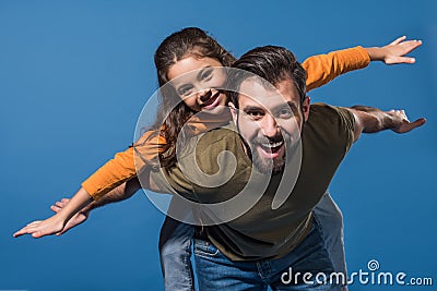 father giving piggyback to daughter Stock Photo