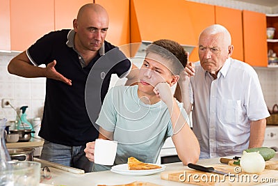 Father and grandfather scolding teenager Stock Photo