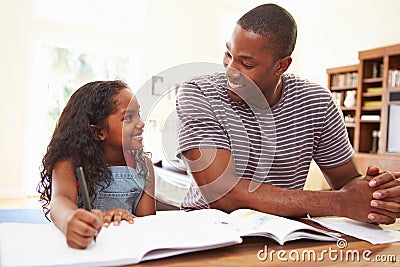 Father Helping Daughter With Homework Stock Photo