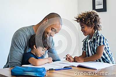 Father helping his sons with homework Stock Photo